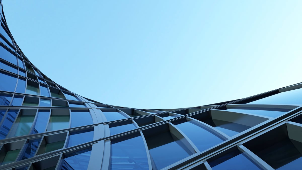 Corporate office building with curved glass window and steel frame, modern commercial architecture